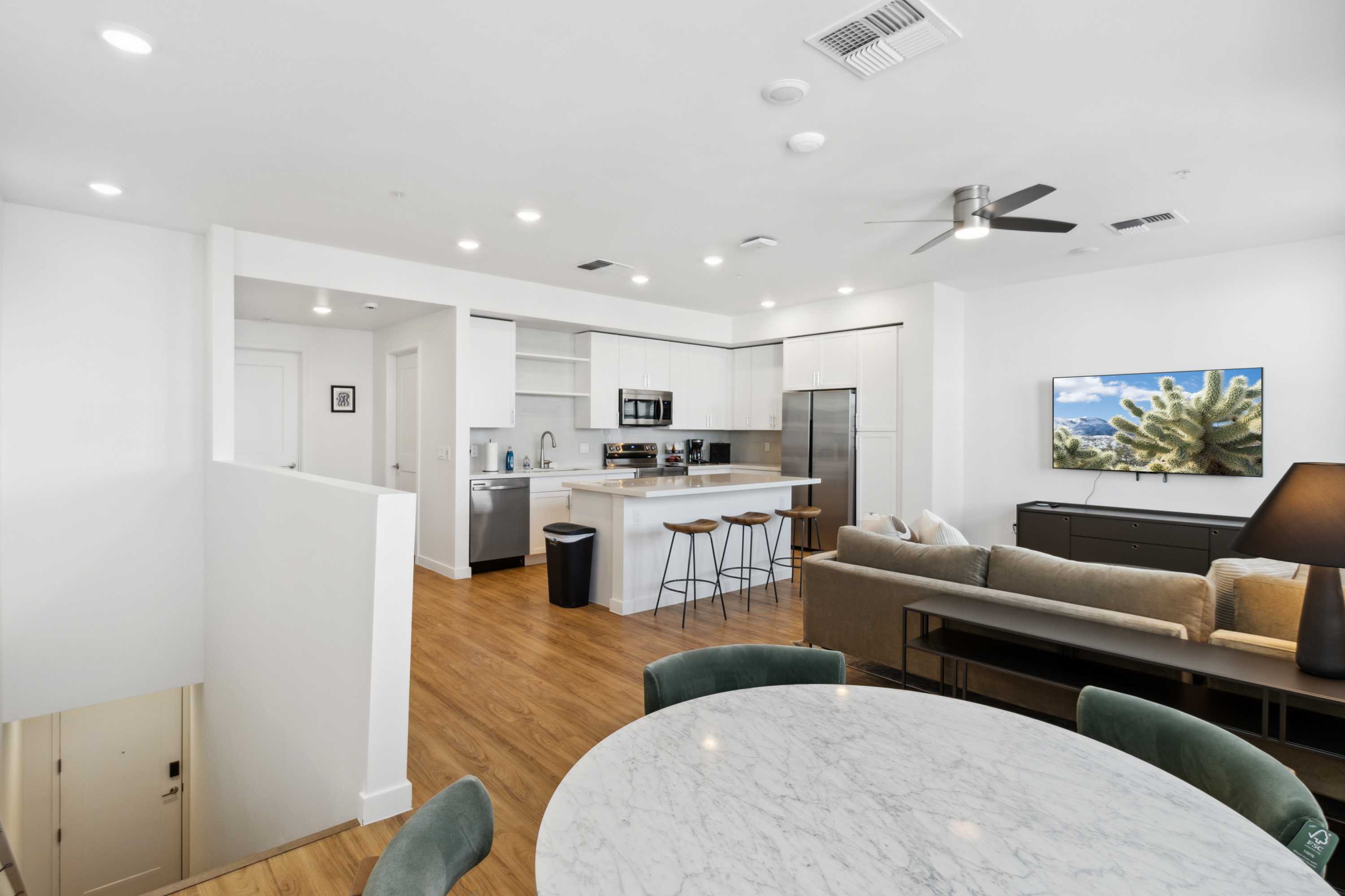 Open-concept living room with modern furnishings and plenty of natural light