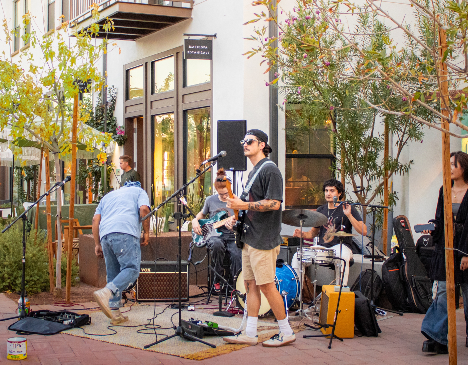 Musician and band playing in outdoor plaza